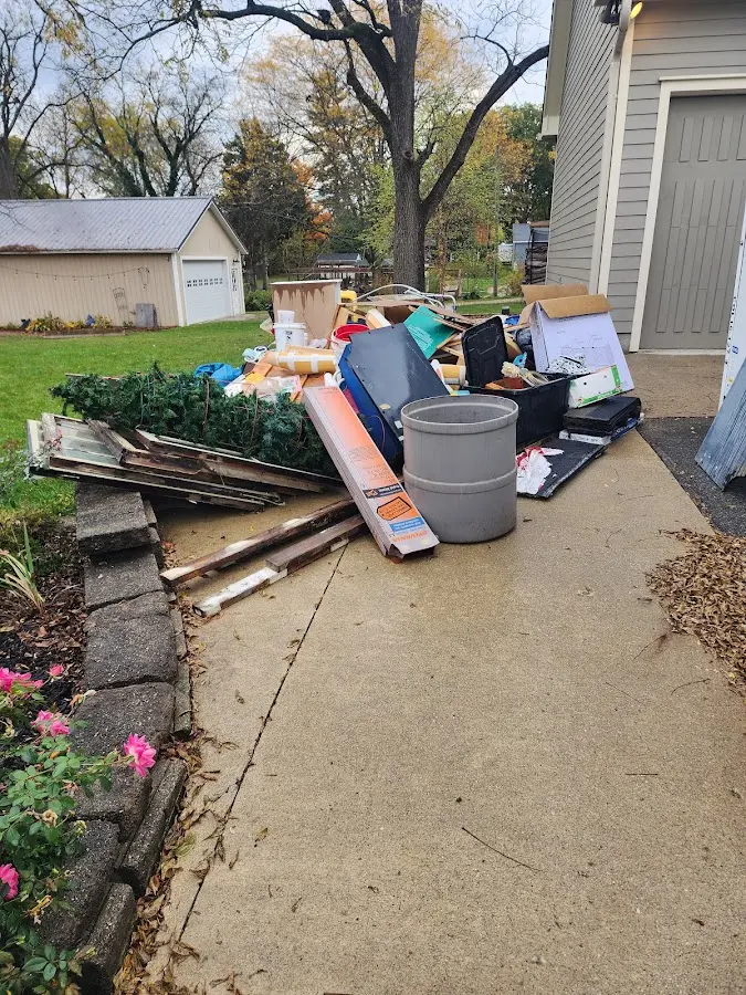 Dumpster being loaded with debris for Estate Cleanout Dumpster Rental in Lenwood